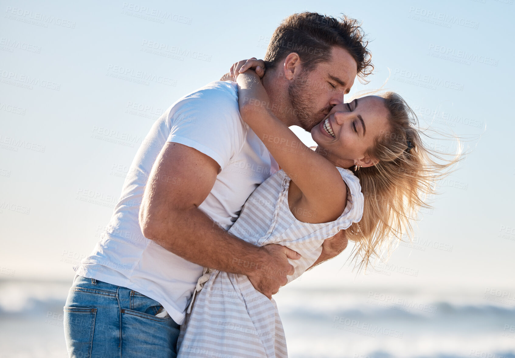 Buy stock photo Love, dating and couple kiss at beach enjoying summer holiday, vacation and honeymoon by the sea. Travel, romance and man and woman show affection, embrace and bonding in nature on weekend together