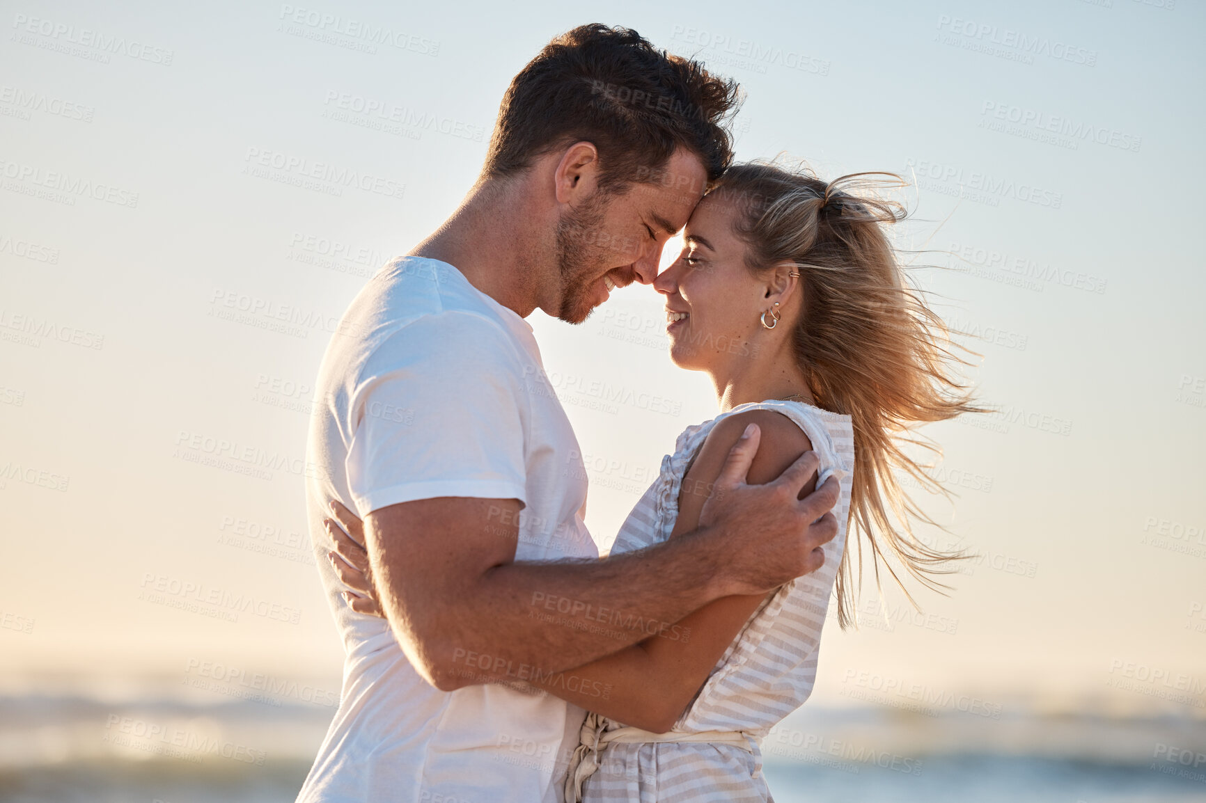 Buy stock photo Love, happy hug and couple relax at beach with happy smile, affection and romance on ocean holiday, romantic travel and sunset coastal vacation. Peace, nature and man embrace a woman by Florida sea 
