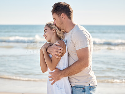 Buy stock photo Beach, happy and couple hugging with love, care and romance while on a honeymoon vacation. Happiness, kiss and loving man embracing his wife from behind by the ocean on a seaside holiday in Maldives.