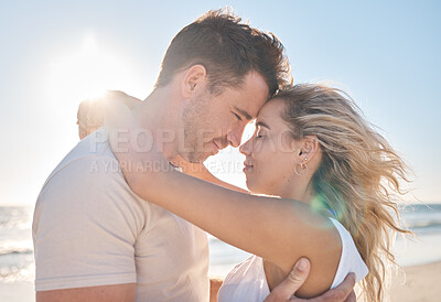 Buy stock photo Love, travel and couple hugging at the beach while on a seaside date or honeymoon vacation. Affection, romance and young man and woman embracing while on a romantic holiday adventure by the ocean.