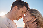 Couple, head touch and love at beach in closeup with romance, care and happiness for relationship. Man, woman and face together for care, bonding and together by ocean for vacation, holiday or summer