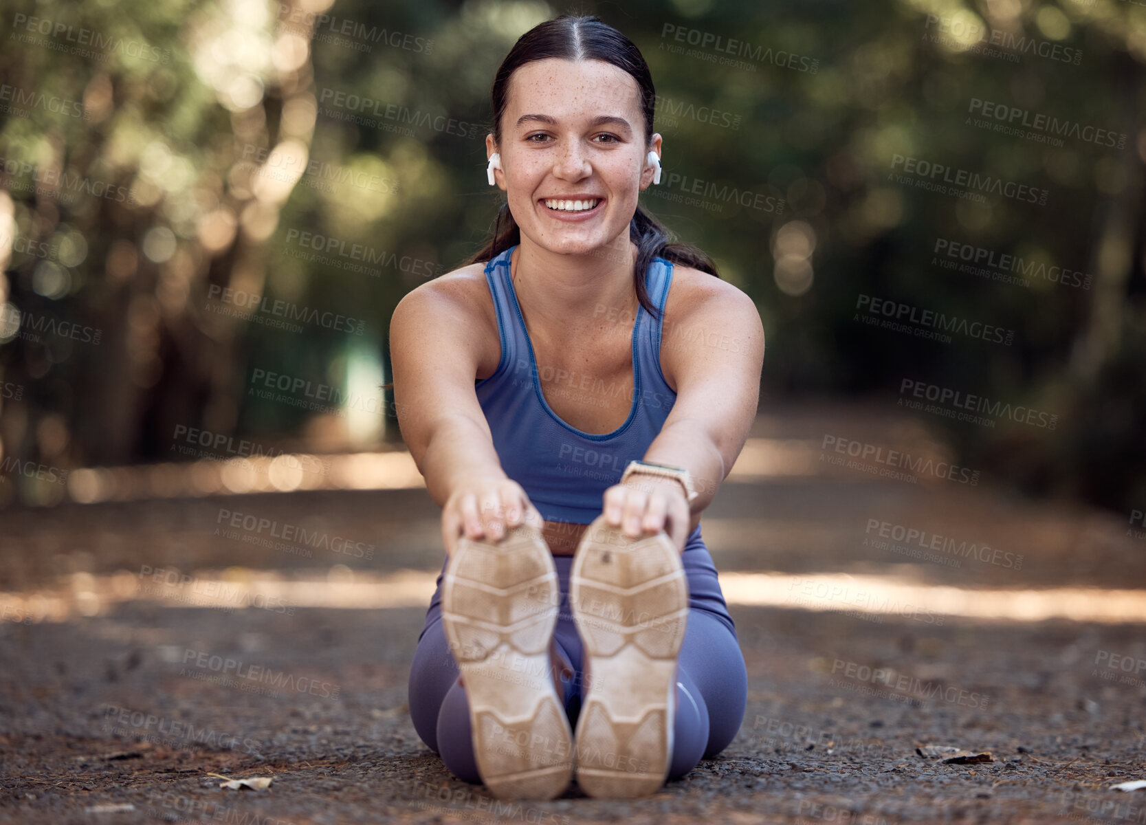 Buy stock photo Earphones, portrait and woman stretching legs in nature while streaming music, radio or podcast. Sports, wellness or female outdoors at park for warm up getting ready for running, training or workout