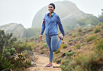 Fitness, woman and runner stretching leg for running exercise, workout or training in nature. Active female exercising in warm up stretch for a mountain trail run for healthy cardio in the outdoors