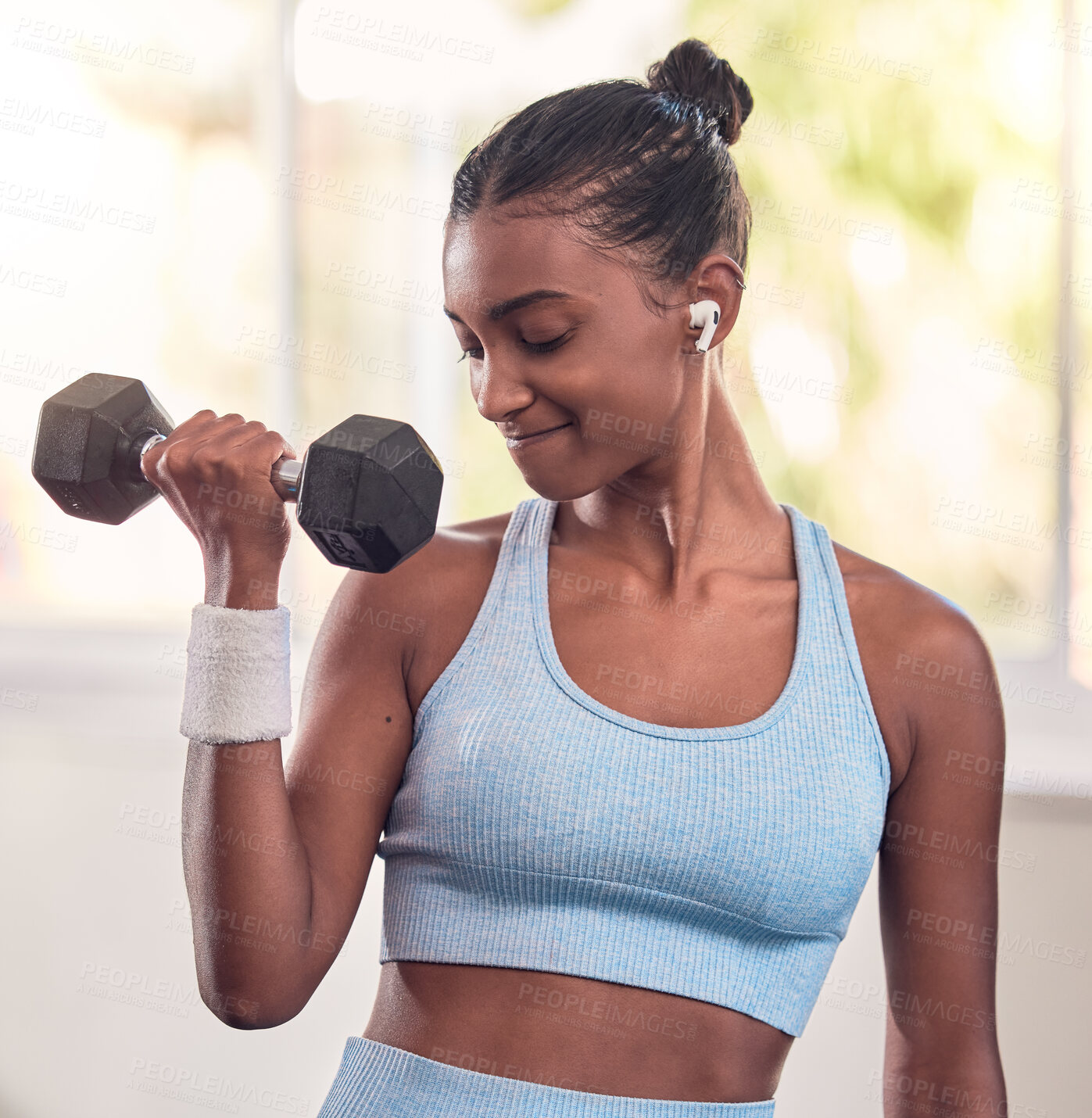 Buy stock photo Woman, dumbbell and music earphones in gym workout, training and exercise for strong arm muscles, body goals or strength target. Indian athlete, personal trainer or fitness coach weightlifting metal