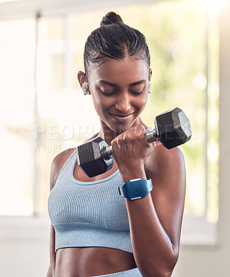 Buy stock photo Fitness, exercise and dumbbell with indian woman, earphone and training in a gym for strong health or wellness. Sports, motivation and workout with a female athlete in a sports club for a workout