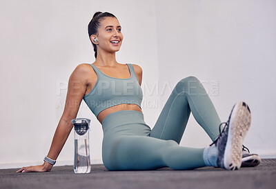 Buy stock photo Relax, fitness and woman on the floor to rest with a water bottle in training, cardio workout or body exercise. Happy, wellness and healthy girl feeling tired or fatigue resting on a break at gym