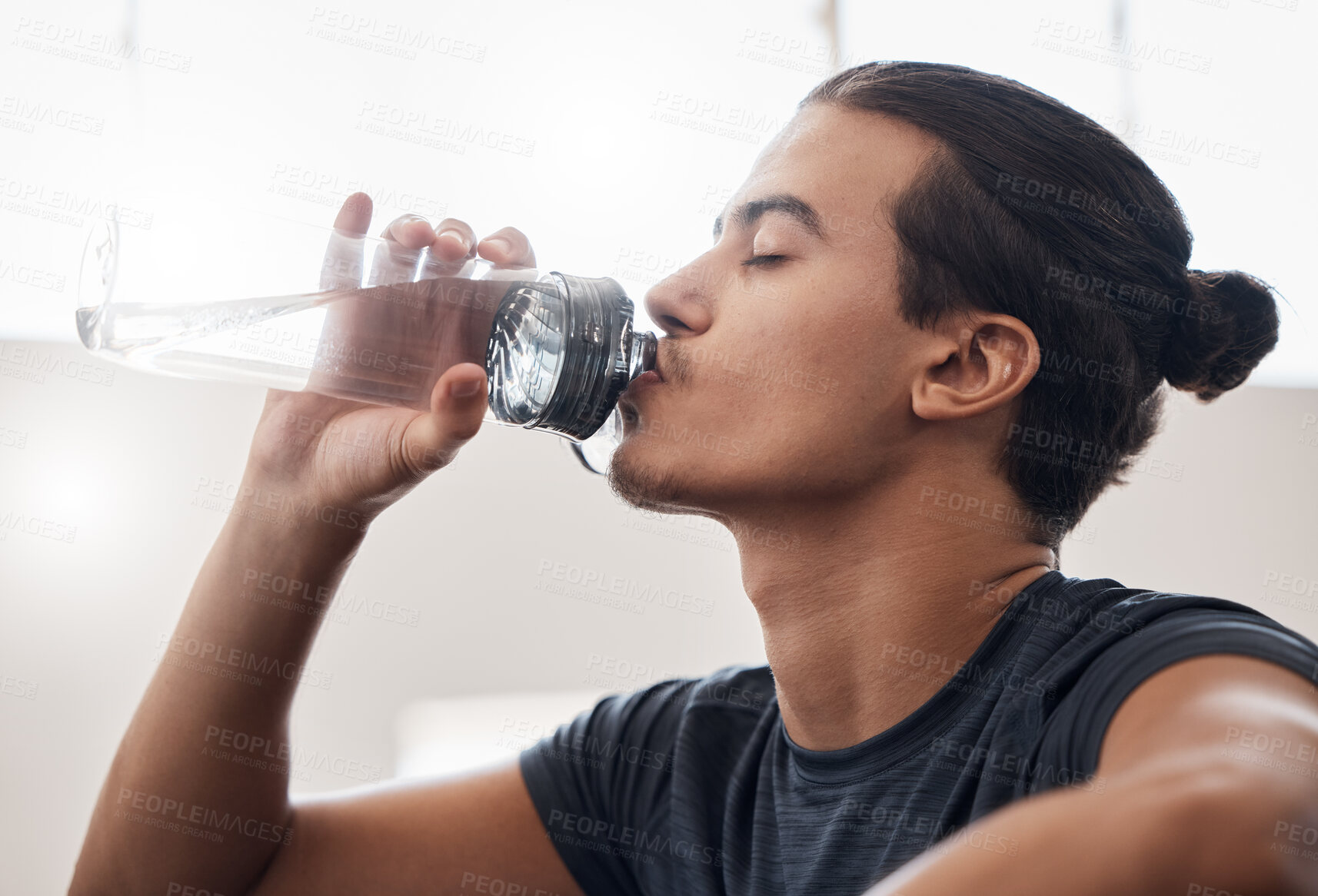 Buy stock photo Tired, fitness or man drinking water in gym for fitness training or health workout exercise. Relax, sports or wellness athlete with water bottle for hydration, sport thirst or rest in studio