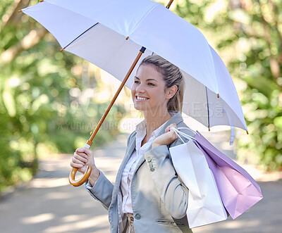Buy stock photo Sun, umbrella and woman with bags from shopping with smile and happy walking in park. Summer, nature and girl with shopping bags from luxury designer boutique and protection from uv rays in sunshine.