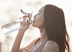 drinking water, fitness and woman after running training, workout and exercise in nature. Wellness, health and morning female athlete with water bottle before runner sport and walking thirsty 