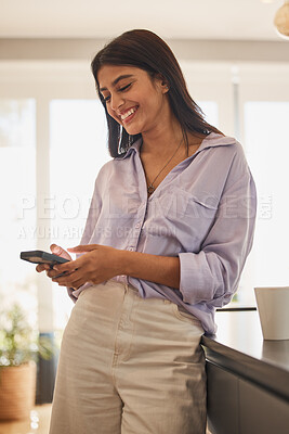 Buy stock photo Woman, phone and social media, funny message or online meme while networking on app, meme and communication in home. Young indian female text on 5g mobile smartphone, internet conversation or reading