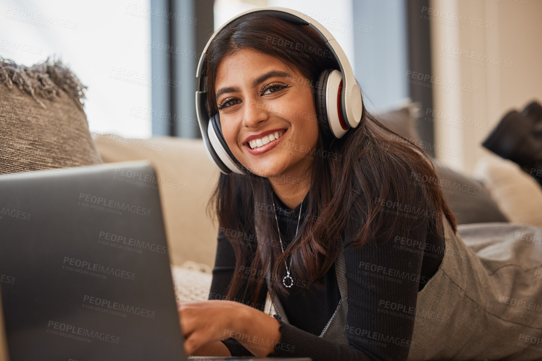 Buy stock photo Woman portrait, headphones and computer video streaming with music feeling happy in a living room. Indian person with happiness smile with technology in a house online on web and social media website