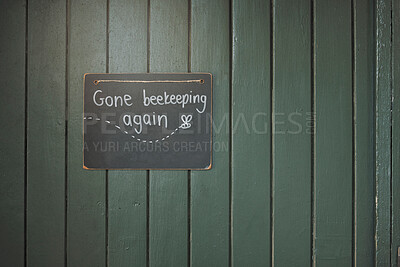 Buy stock photo Door, sign and beekeeping with a chalkboard hanging on an entrance way of a small business in agriculture. Wood, store and retail with a notice on a wooden surface for farming or sustainability