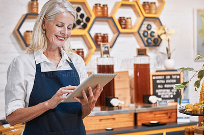 Buy stock photo Happy small business owner, tablet or senior woman in honey retail store for research, communication or networking. Smile, honey or manager with social media app update, online store or order review