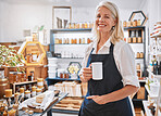 Coffee, portrait and senior small business entrepreneur standing in her retail wellness shop. Leader, owner and portrait of a professional elderly woman boss drinking cup of tea in her startup store.