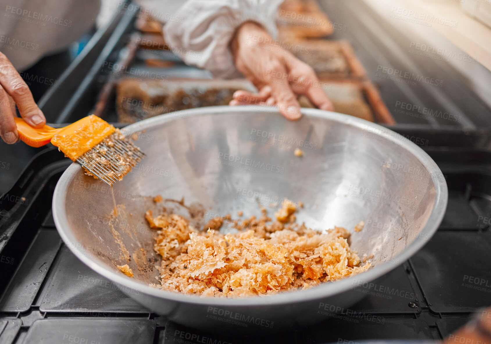 Buy stock photo Hands, honeycomb and bowl for organic food processing, preparation or extract at the workplace. Hand of beekeeper working in honey making, extraction or agriculture for food, retail or producing
