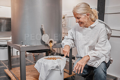 Buy stock photo Happy, smile and beekeeper working with honey for eco friendly, organic and natural production at warehouse. Business owner with happiness for the process of sweet food from a machine in agriculture