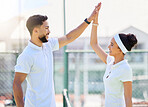 Tennis, high five and motivation with a sports couple in celebration of an achievement as a winner team. Fitness, workout and success with a man and woman tennis player on a tennis court together