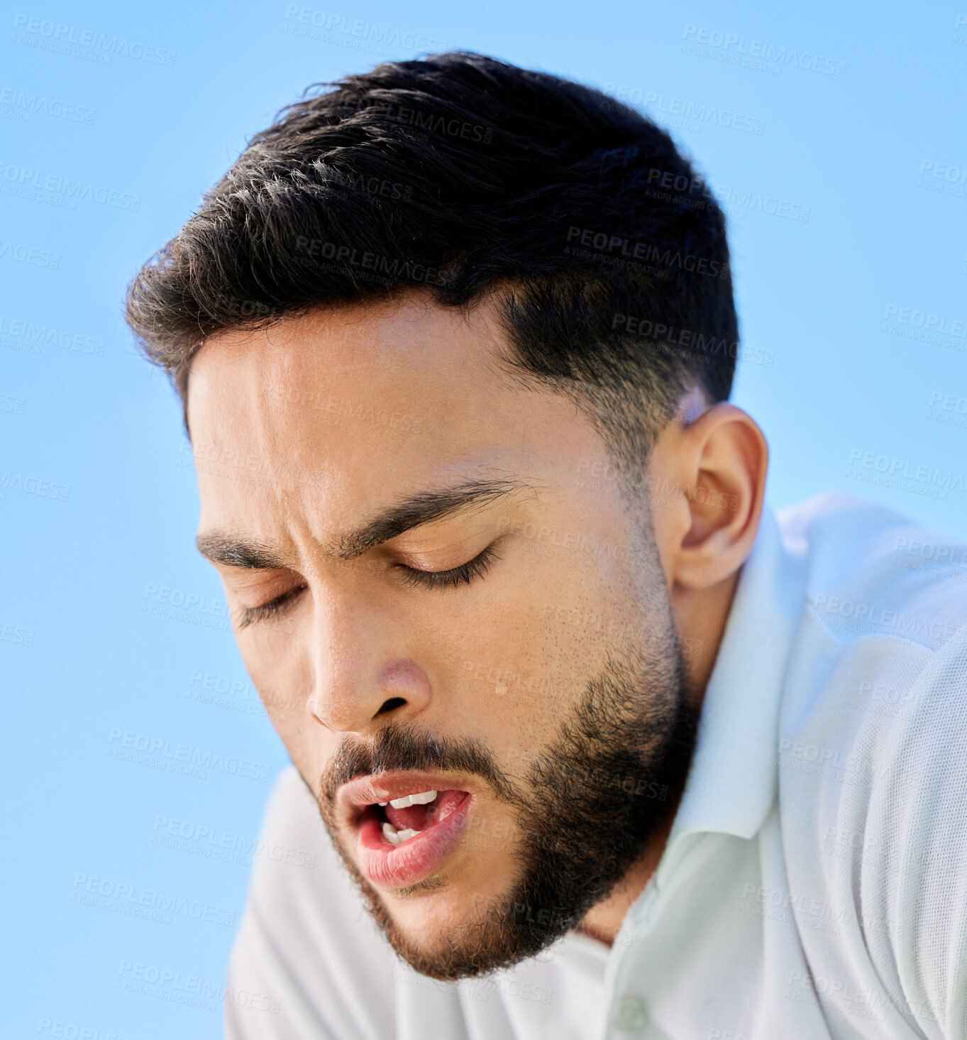 Buy stock photo Tennis, fitness and tired man face or fatigue from exercise, cardio workout or training. Breathing, fatigue and healthy sports male relaxing or resting on a break from sports training with blue sky 