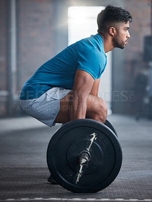 Buy stock photo Fitness, deadlift and man in gym in a workout, exercise or strength training for strong powerful legs and core. Focus, wellness and healthy Indian sports bodybuilder weightlifting a heavy barbell 