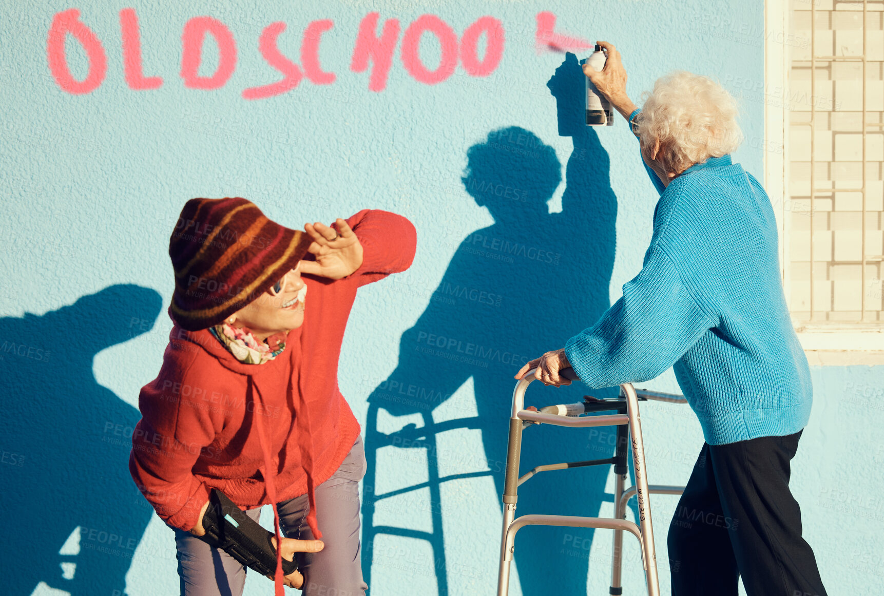 Buy stock photo Senior women, friends and spray paint for vandalism, graffiti and street art to spray old school on nursing home building wall and keep watch. Crazy old people break law with illegal activity outdoor