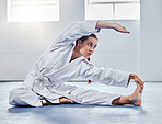 Martial arts, karate or woman stretching before training practice, fitness workout or challenge competition. Girl, warrior or taekwondo fighter warm up for dojo self defense or safety security lesson