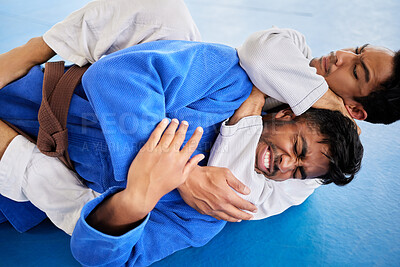 Buy stock photo Men, martial arts and karate choke hold in dojo to practice fighting skill. Training, taekwondo and fitness class for self defense, workout or exercise challenge with people in match or competition.