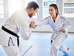 Man, karate and coach training woman in fitness, workout and exercise class for competition, black belt fight or self defense. Sports athlete, judo teacher and student in taekwondo power punch goals