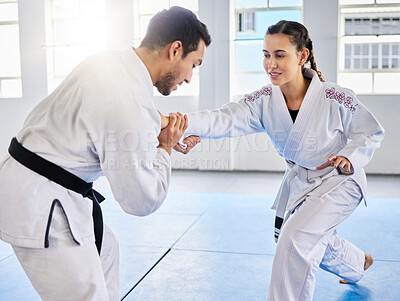 Buy stock photo Man, karate and coach training woman in fitness, workout and exercise class for competition, black belt fight or self defense. Sports athlete, judo teacher and student in taekwondo power punch goals