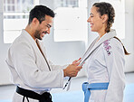 Karate, belt and martial arts coach happy with fitness, workout and taekwondo student progress. Sports training achievement, ceremony and win of a woman after a fight exercise in a health gym studio