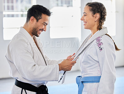 Buy stock photo Karate, belt and martial arts coach happy with fitness, workout and taekwondo student progress. Sports training achievement, ceremony and win of a woman after a fight exercise in a health gym studio