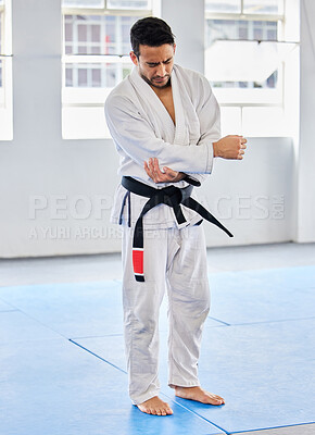 Buy stock photo Karate injury, hurt and elbow pain for a man athlete holding painful arm at the gym. Active, Sport and athletic male suffering from muscle inflammation due to an exercise, fight training or workout