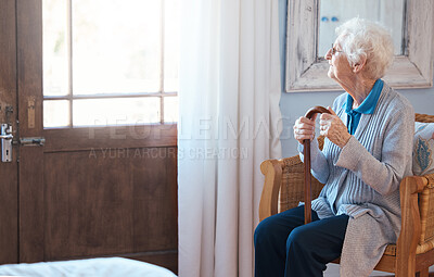 Buy stock photo Thinking, sad and senior woman thinking of life with a walking stick by the window in the room in a retirement house. Elderly female with depression, disability and retirement idea in a nursing home
