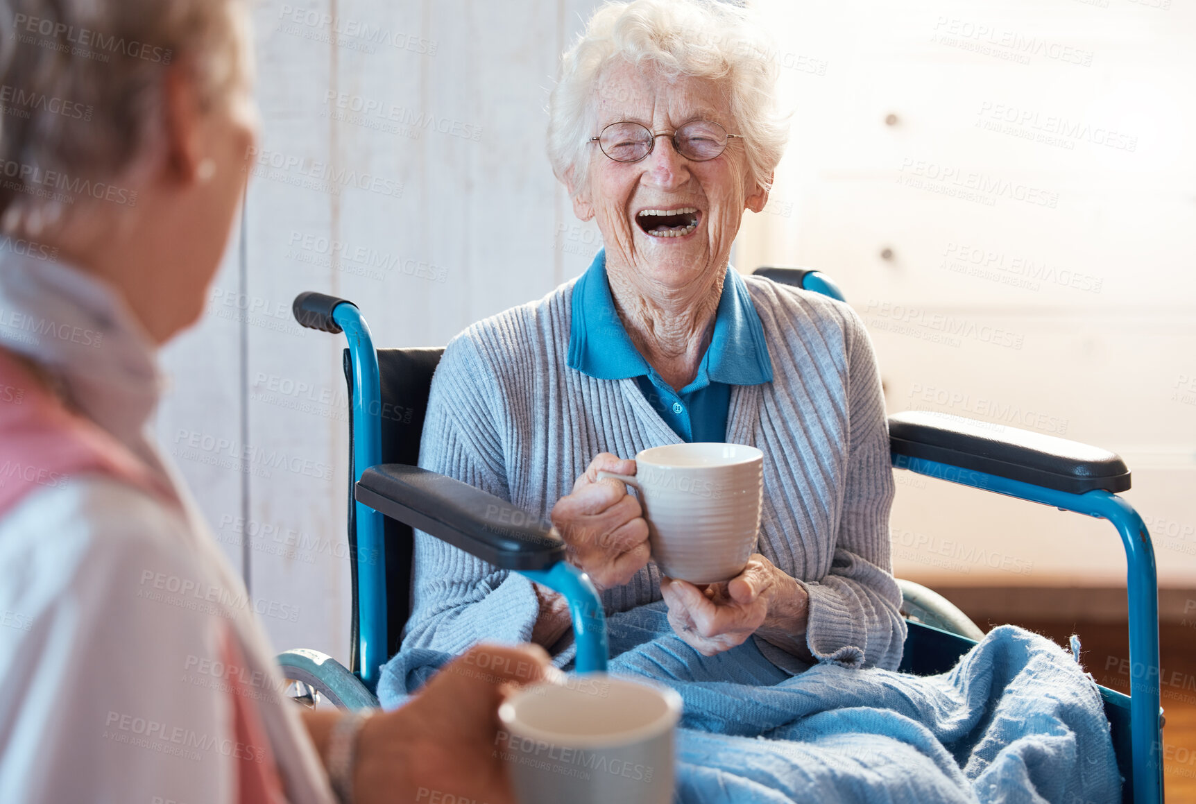 Buy stock photo Senior woman, friend and coffee or tea while in a wheelchair for a disability or rehabilitation and happy or laughing about funny conversation or joke. Old people together for fun in nursing home