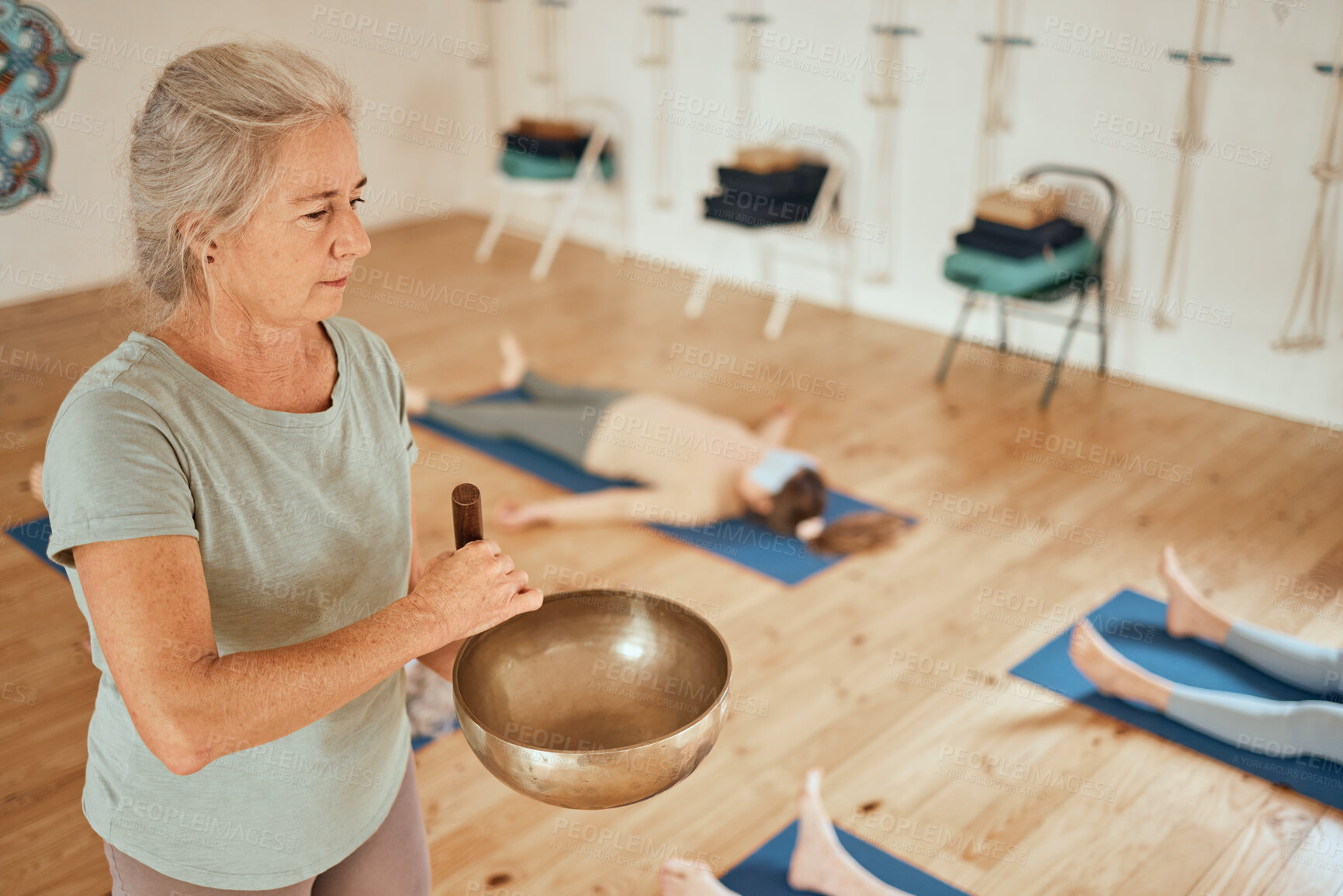 Buy stock photo Meditation, class and woman with Tibetan singing bowl for calm, peace and zen in gym studio. Spiritual healing, mindfulness and senior fitness coach in yoga, exercise and pilates lesson for wellness