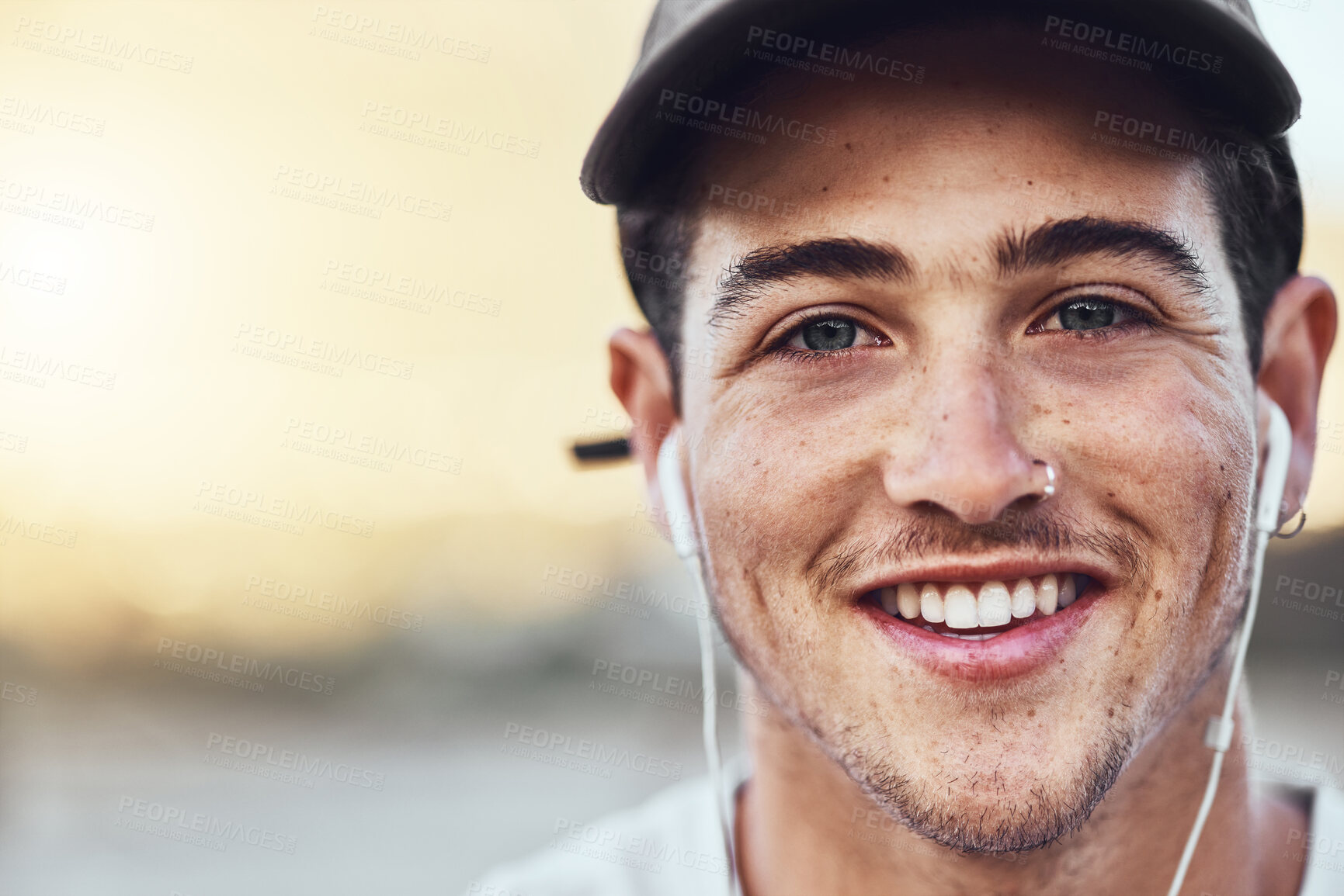 Buy stock photo Earphones, smile and face portrait of a man in the city listening to music with a positive mindset. Happy, young and handsome guy streaming audio, radio or podcast in an urban town with mockup space.