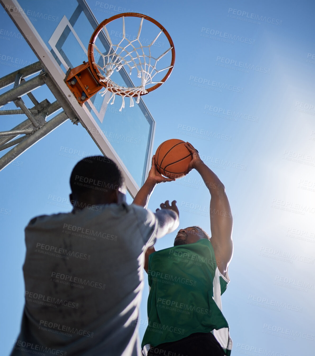 Buy stock photo Basketball player, low angle and competition games on blue sky background of outdoor sports, fitness and energy for goals, performance and action. Basketball hoop, friends and men, court and training