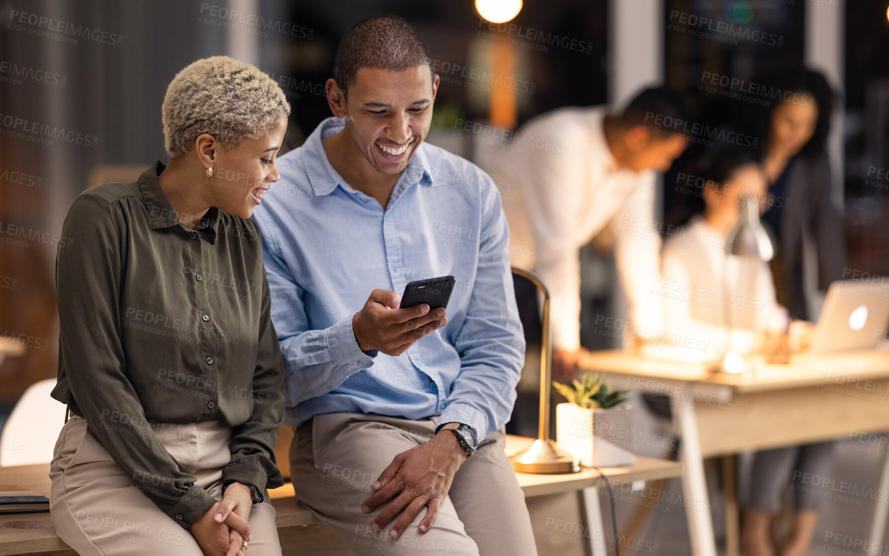 Buy stock photo Phone, collaboration and team in discussion in office scrolling on social media, web or internet. Happy, conversation and corporate employees on smartphone while on break together in modern workplace