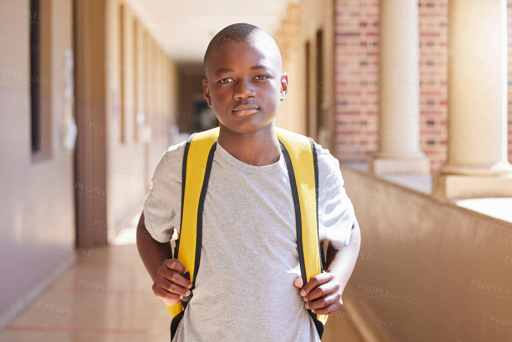 Buy stock photo Education, backpack and portrait of a child at school ready to learn or study in a classroom. Student, knowledge and African boy kid standing with his bag in the hallway at his high school campus.
