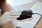 Computer mouse, hand and wipe to disinfect during covid for health, government compliance and wellness at workplace. Gloves on woman at office for covid 19 virus sanitizer and cleaning of equipment