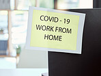 Covid, sign and work from home at the office for health and safety rules or regulations during pandemic. Label post of corona virus restrictions for working remote, quarantine or control at workplace