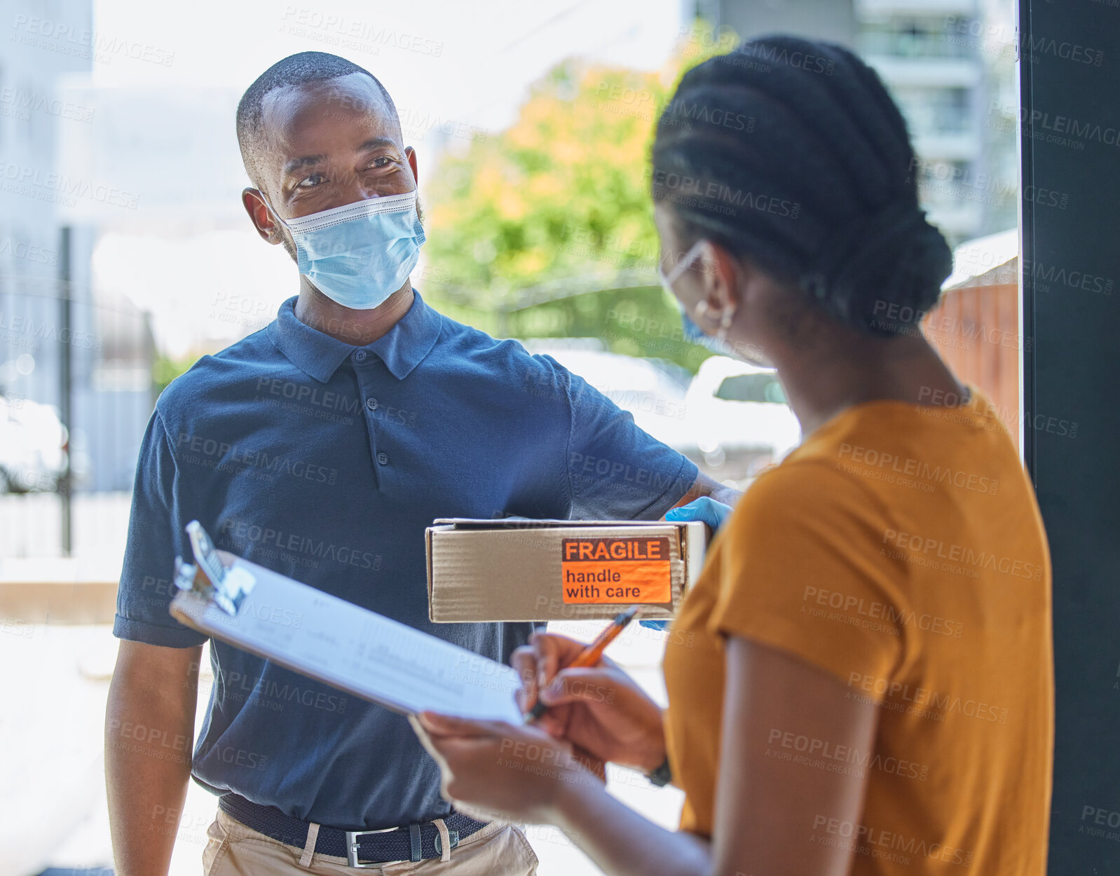 Buy stock photo Covid, delivery and man with a box for a black woman in face mask for coronavirus compliance after online shopping. Ecommerce, thank you and African girl customer signing paper on a clipboard at door