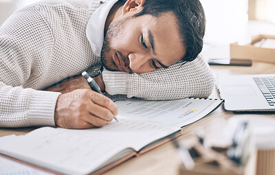 Buy stock photo Bored, writing and diary with a business man lying on his desk at work while making note of an appointment. Schedule, calendar and notebook with a male employee working on an idea while feeling tired