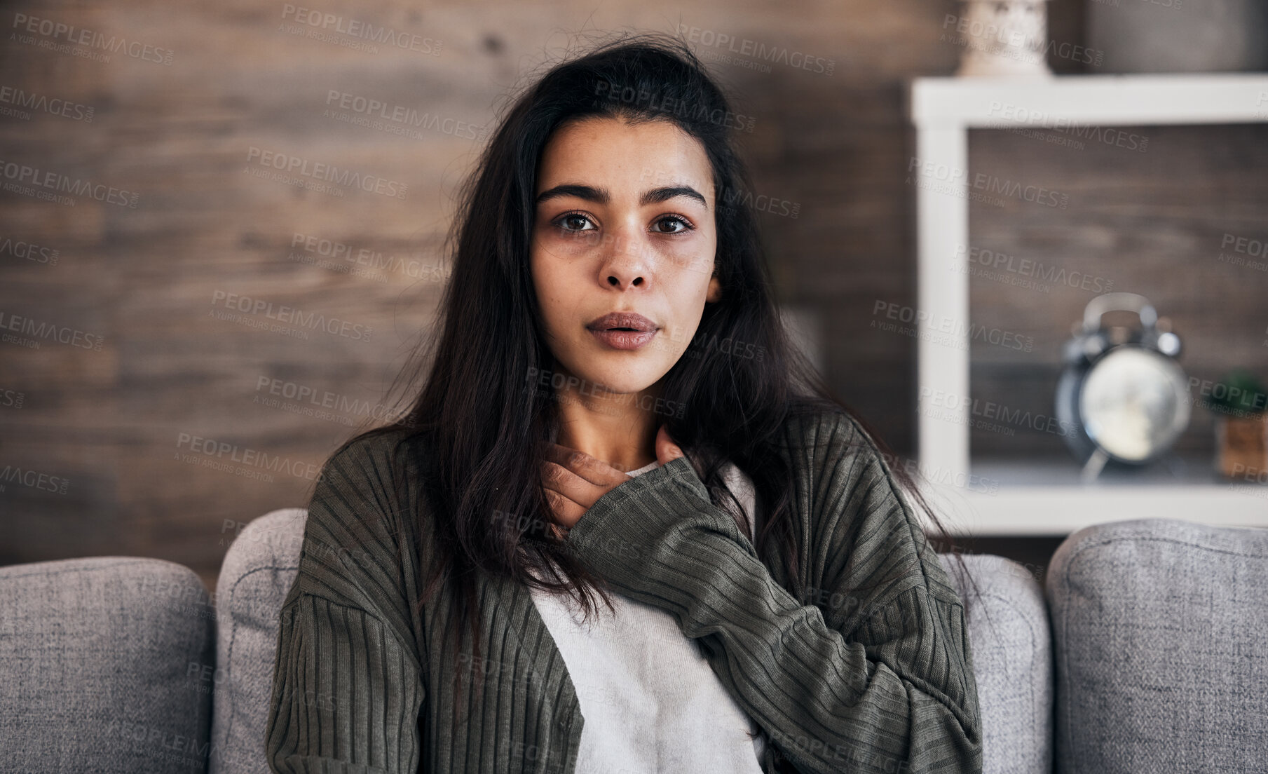 Buy stock photo Anxiety, worry and woman breathing on sofa to relax, calm down and stress relief from panic attack. Mental health, depression and portrait of anxious girl sitting on couch with hand on chest in pain