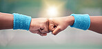 Tennis, closeup and fist bump for success, motivation and teamwork with blurred background while outdoor. Tennis player, hands and touch for respect, team building and support at training in summer