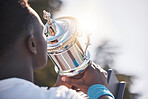 Trophy, winner and black man with sports achievement, goal and success on sky mockup and sunshine for champion reward. Competition, winning and athlete with prize, fitness celebration and game event