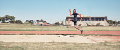 Buy stock photo Long jump, athletics and fitness with a sports man jumping into a sand pit during a competition event. Health, exercise and training with a male athlete training for competitive track and field