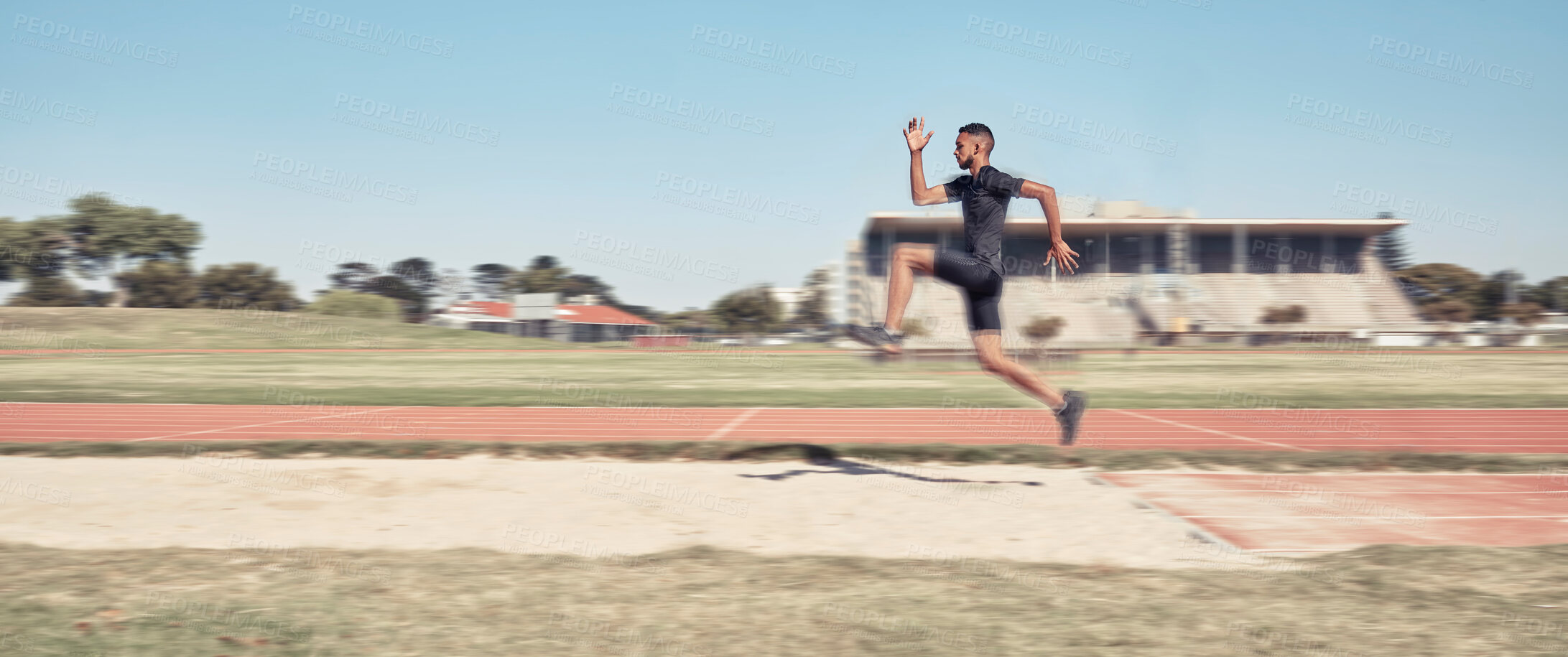 Buy stock photo Long jump, athletics and fitness with a sports man jumping into a sand pit during a competition event. Health, exercise and training with a male athlete training for competitive track and field