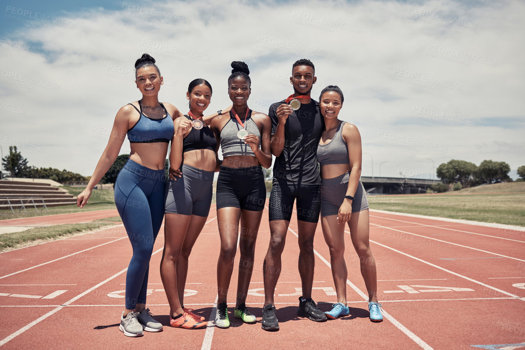 Buy stock photo Champion, group and runner, winner and medal for running and fitness outdoor, race track and athlete winning race. Diversity, black man and women at stadium, win in sports and training portrait.