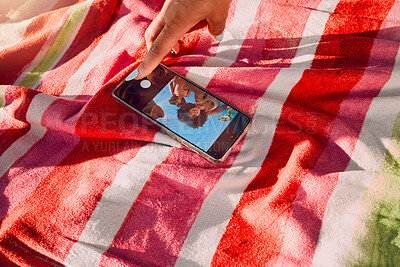 Buy stock photo Hand, phone and selfie by friends at a beach for travel, fun and picture on towel, finger and screen. Women, hands and social media influencer set timer for recording, content creator and smartphone