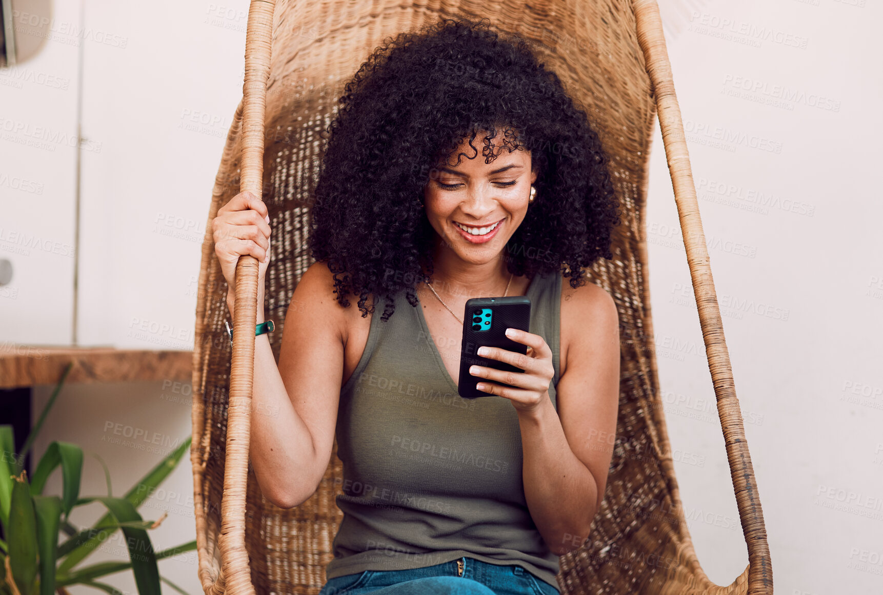 Buy stock photo Black woman, phone and smile for communication, social media and streaming online with wifi in a rustic wood swing chair. Female with a smile, smartphone and happiness during chat on network